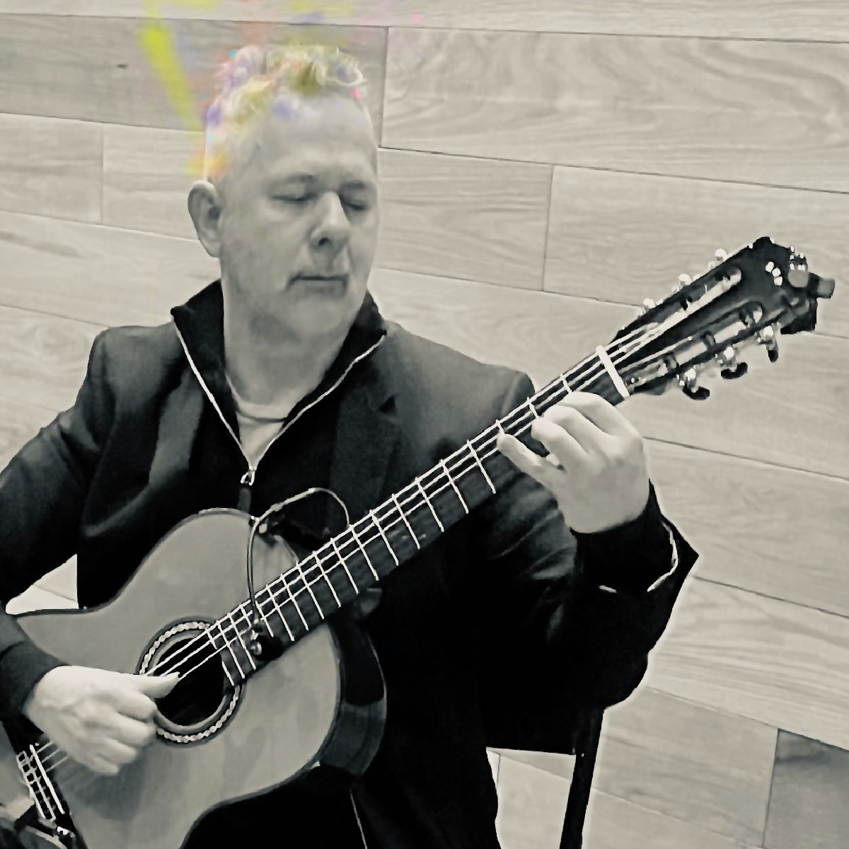 Edwin O. Munera playing acoustic guitar