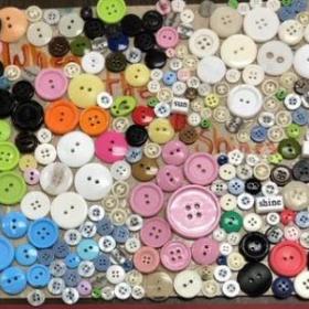 collage of colorful buttons and beads. "we shine together"