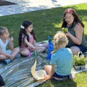 image of children working outdoors on a project